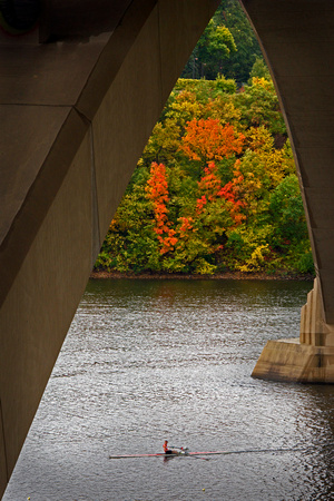 Single shell rower under the Lake Street Bridge